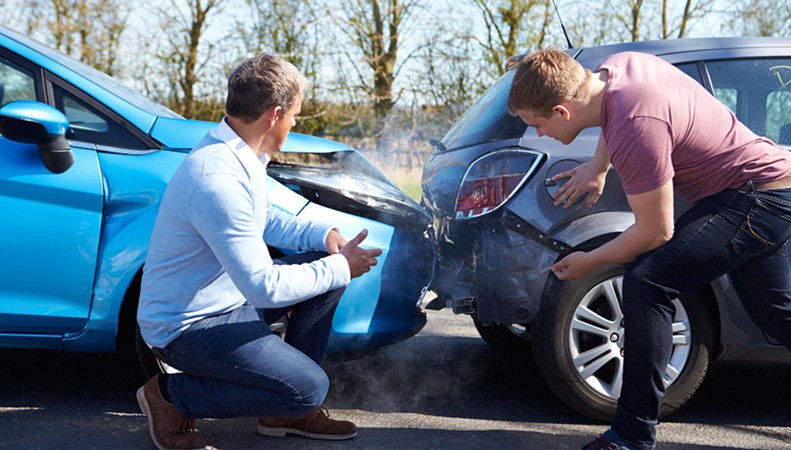 Technician repairing minor car dent and paint scratch damage
